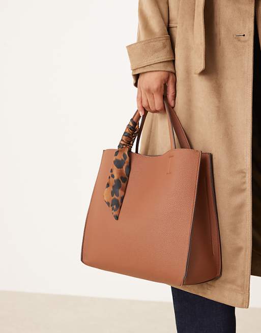 Accessorize handheld box bag with leopard print scarf in tan