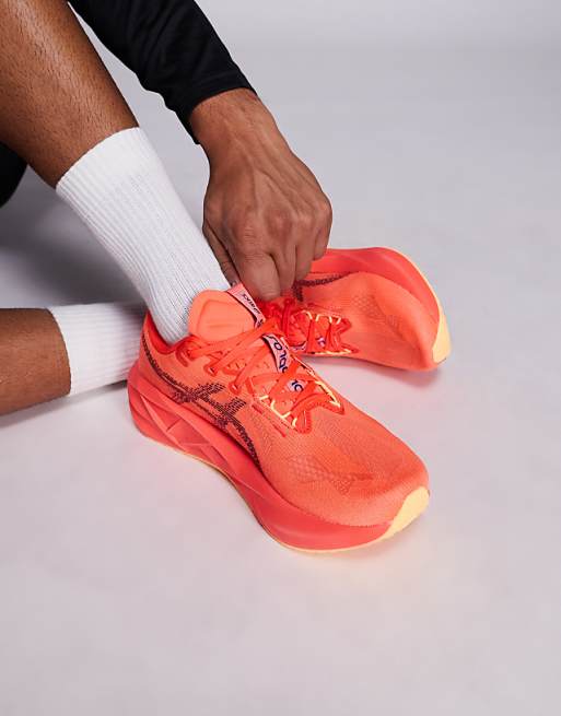 Asics Novablast 5 running trainers in flash red and edo purple