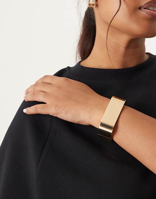 DESIGN bangle with oval shape design in gold tone