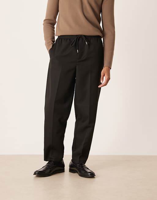 DESIGN carrot fit trousers with elasticated waistband in black