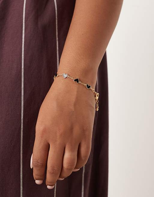 DESIGN Curve chain bracelet with black enamel heart details in gold tone