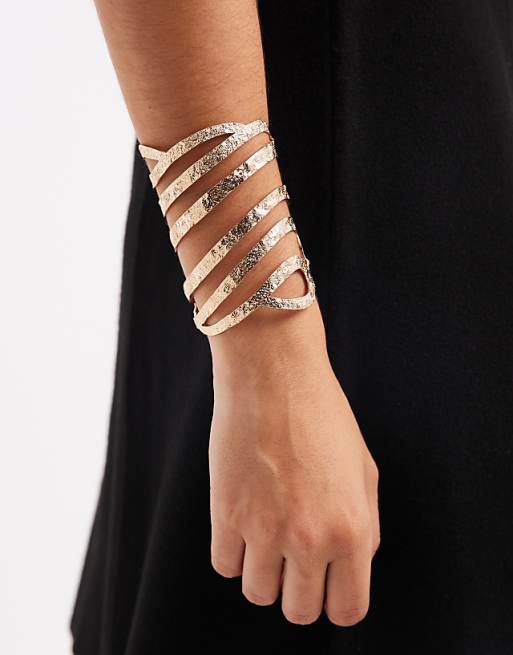 DESIGN large cuff bracelet with cut-out design in hammered gold tone