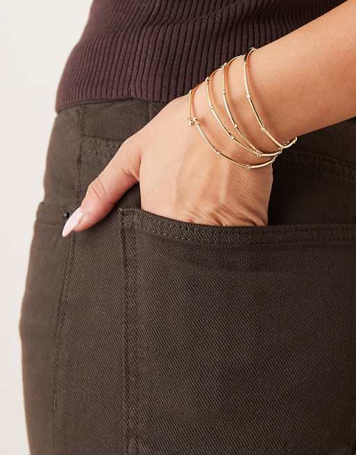 DESIGN multi-row stretch bracelets in gold tone