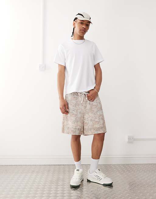 DESIGN oversized short with all over foliage print in beige