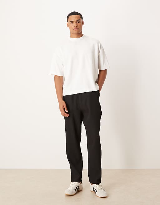 DESIGN plisse tapered trousers in black