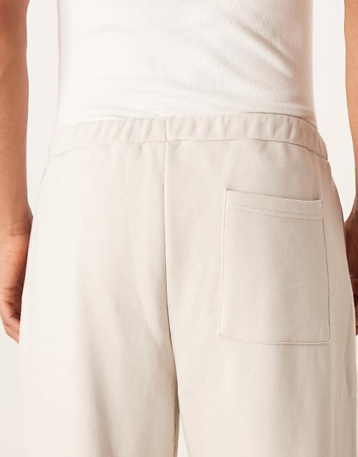 DESIGN Relaxed Tapered Joggers With Pleats In Stone