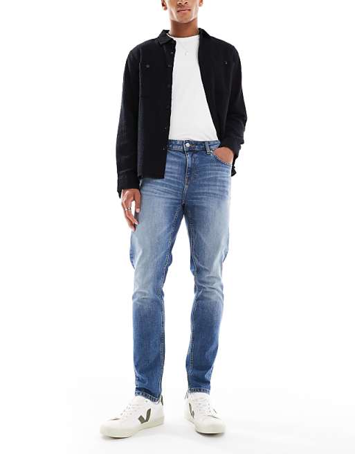 DESIGN skinny jeans in mid wash blue