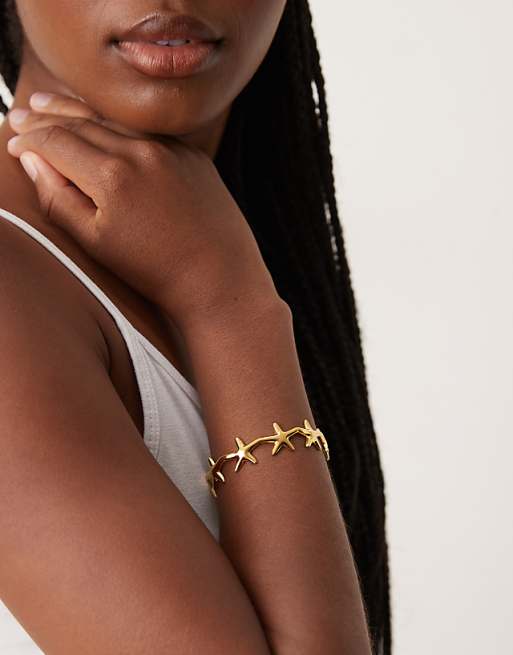 DESIGN stainless steel waterproof cuff bracelet with mini starfish detail in gold tone