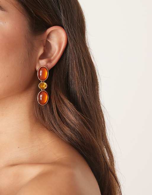 DESIGN stud earrings with faux stone-set pendants in amber tones