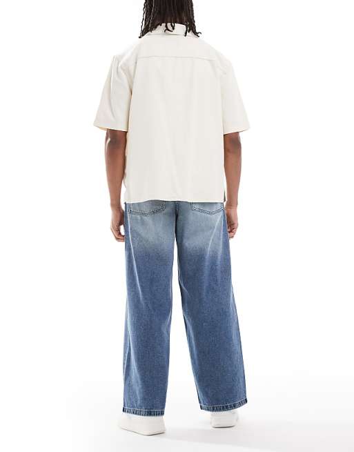 DESIGN Super Baggy Fit Jeans In Mid Wash Blue With Tint