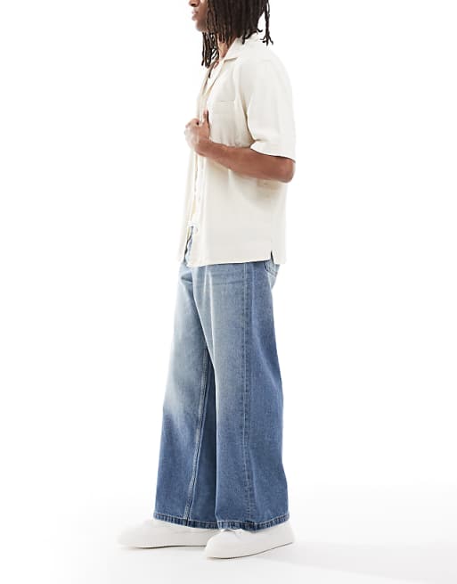 DESIGN Super Baggy Fit Jeans In Mid Wash Blue With Tint