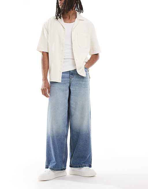DESIGN super baggy fit jeans in mid wash blue with tint