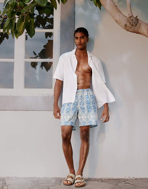 DESIGN swim short in mid length with ornate floral in blue