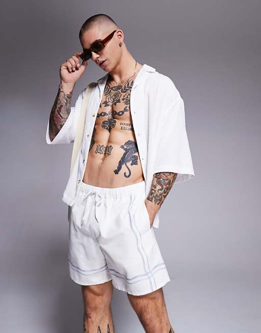 DESIGN swim shorts in mid length in stone with border print