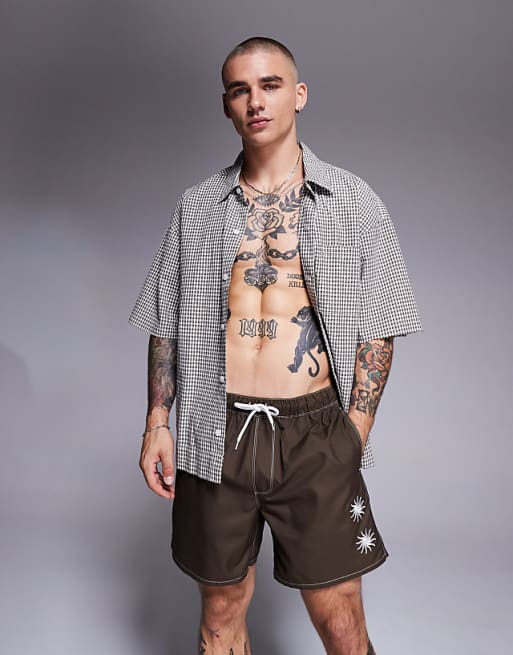 DESIGN swim shorts in mid length with sun embroidery in brown