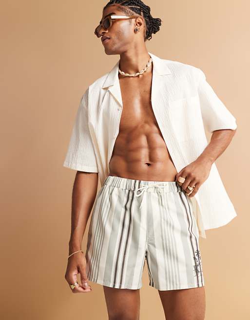 DESIGN swim shorts in short length in cream stripe with placement print