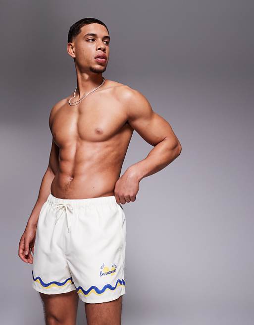 DESIGN swim shorts in short length with border print in stone