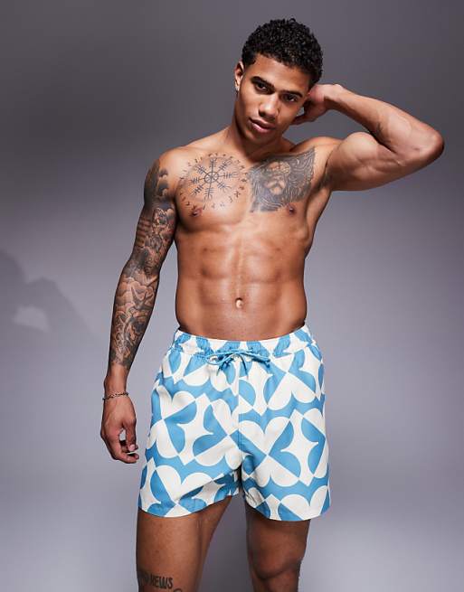 DESIGN swim shorts in short length with geo print in blue