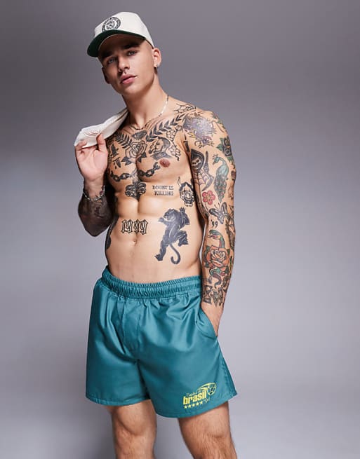 DESIGN swim shorts in short length with placement print in green