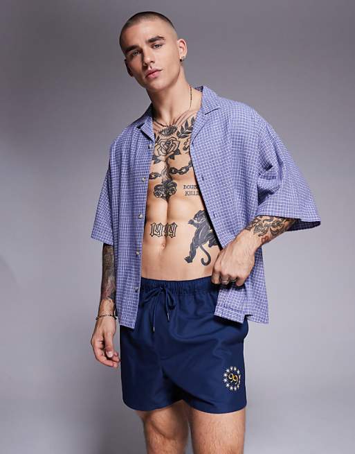 DESIGN swim shorts in short length with placement print in navy