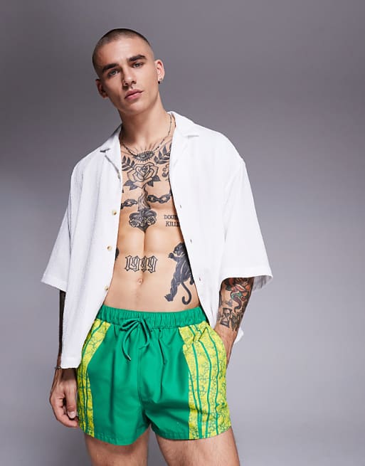 DESIGN swim shorts in super short length with placement animal print in green