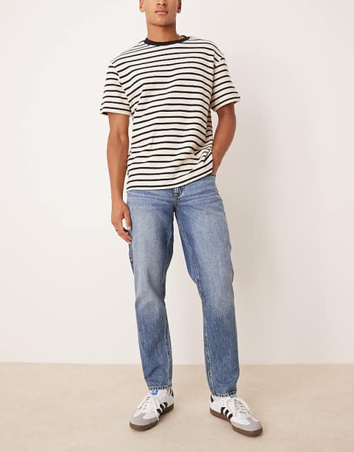 DESIGN tapered fit jeans in mid wash blue