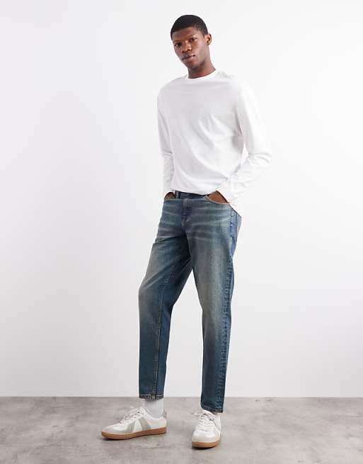 DESIGN tapered fit jeans with tint in mid wash blue