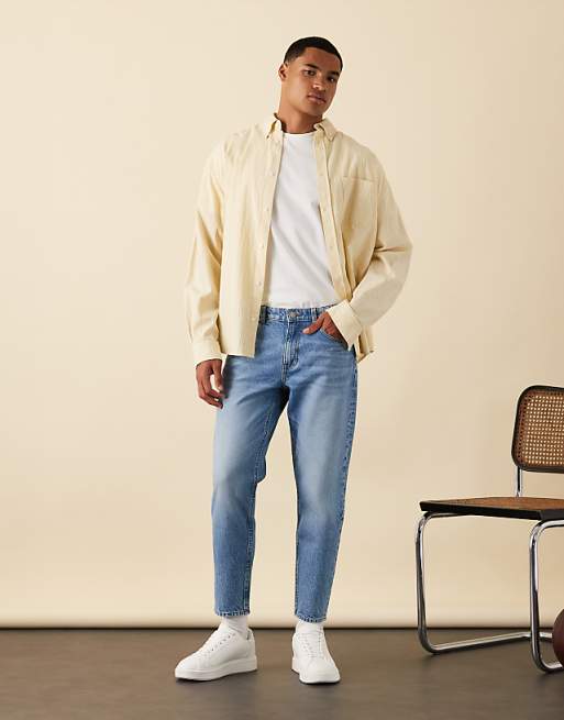 DESIGN tapered jeans in light wash blue