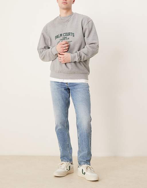 DESIGN tapered jeans in mid wash blue
