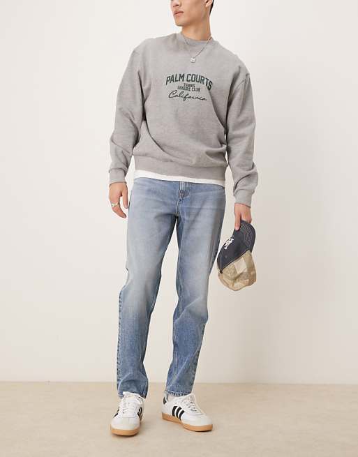 DESIGN tapered jeans in mid wash blue