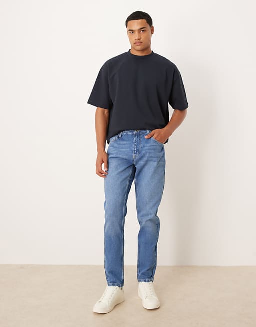 DESIGN tapered jeans in mid wash