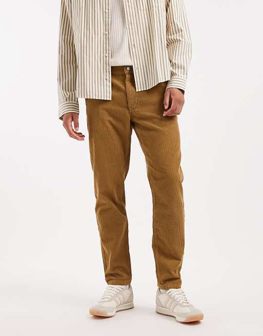 DESIGN tapered trousers in brown corduroy
