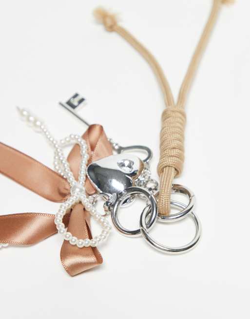DesignB London Bungee Cord And Pearl Bow Bag Charm In Brown