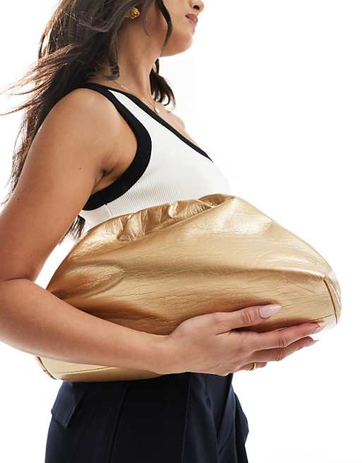 Glamorous pillow clutch bag in metallic gold