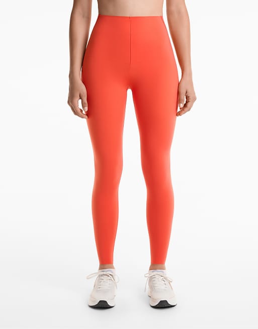 OYSHO Compressive reflective high rise ankle-length leggings in orange